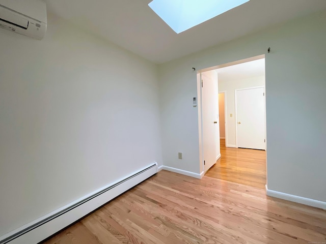 25 Old Middle Rd, Brookfield, CT 06804 - unfurnished room featuring a baseboard radiator, a wall mounted AC, a skylight, light wood-style flooring, and baseboards