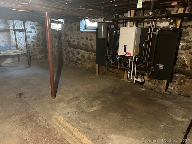 basement featuring tankless water heater