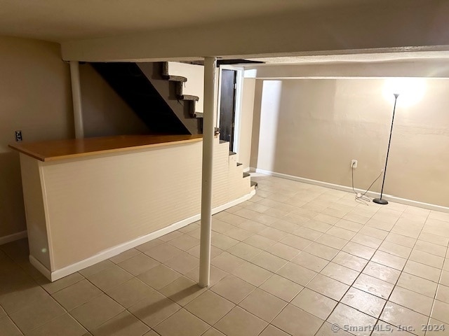 basement featuring light tile patterned floors