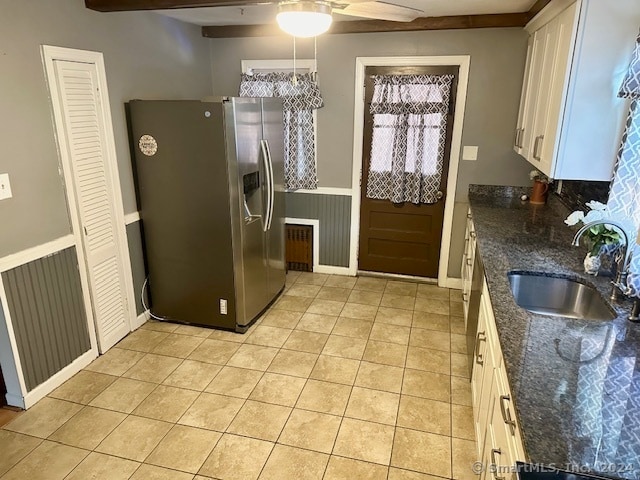 kitchen with stainless steel fridge with ice dispenser, white cabinets, sink, ceiling fan, and dark stone counters