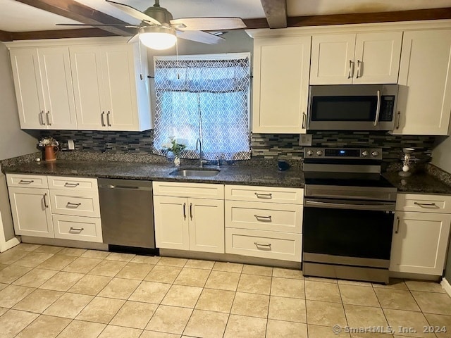 kitchen with white cabinets, appliances with stainless steel finishes, sink, light tile patterned flooring, and ceiling fan