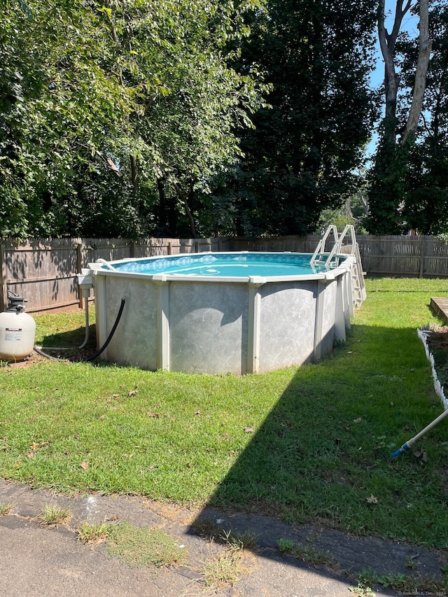 view of pool featuring a yard