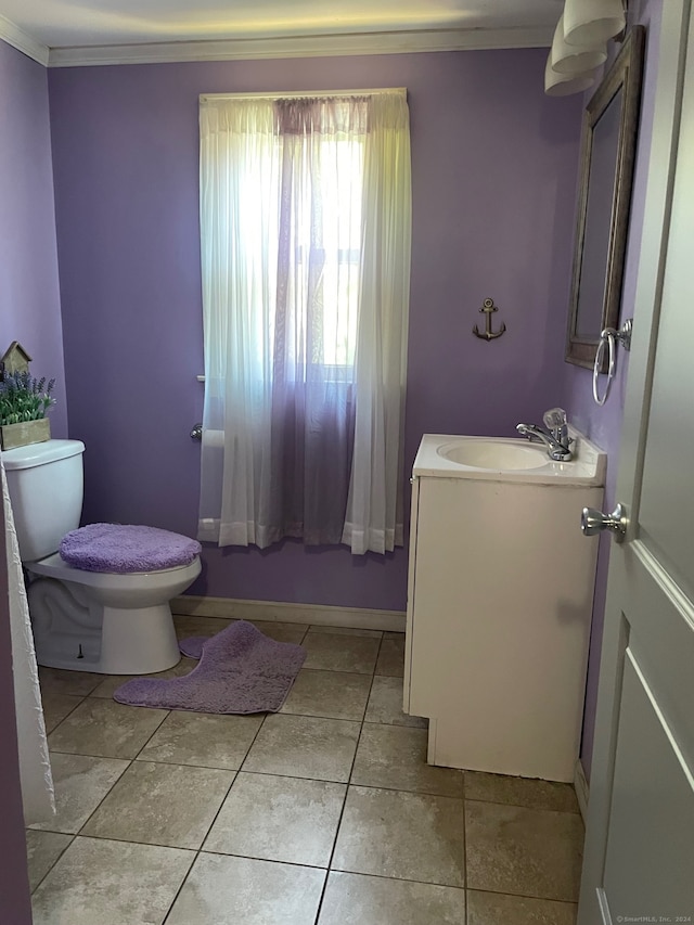 bathroom with crown molding, vanity, toilet, and tile patterned flooring