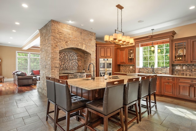 162 Balfour Dr, West Hartford, CT 06117 - kitchen featuring a sink, ornamental molding, stainless steel appliances, backsplash, and a breakfast bar area