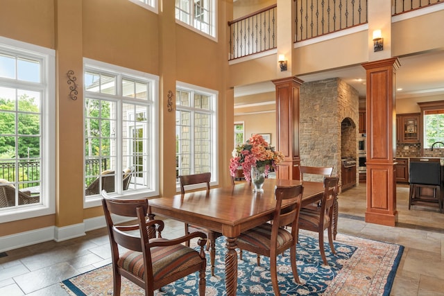 162 Balfour Dr, West Hartford, CT 06117 - dining space with ornate columns, plenty of natural light, stone tile flooring, a high ceiling, and crown molding