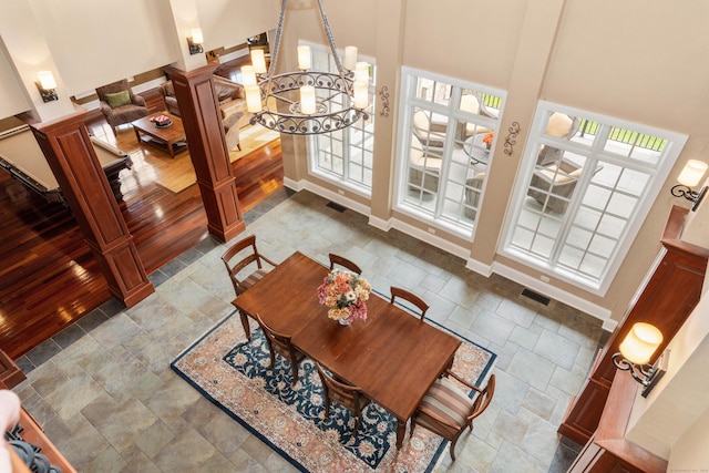 162 Balfour Dr, West Hartford, CT 06117 - dining area with a high ceiling, stone finish floors, a chandelier, and baseboards