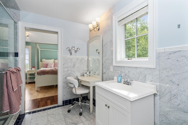 162 Balfour Dr, West Hartford, CT 06117 - bathroom featuring ensuite bathroom, tile walls, vanity, and a shower with shower door
