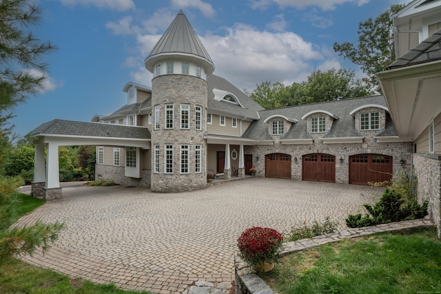 162 Balfour Dr, West Hartford, CT 06117 - back of house with decorative driveway, stone siding, and a garage