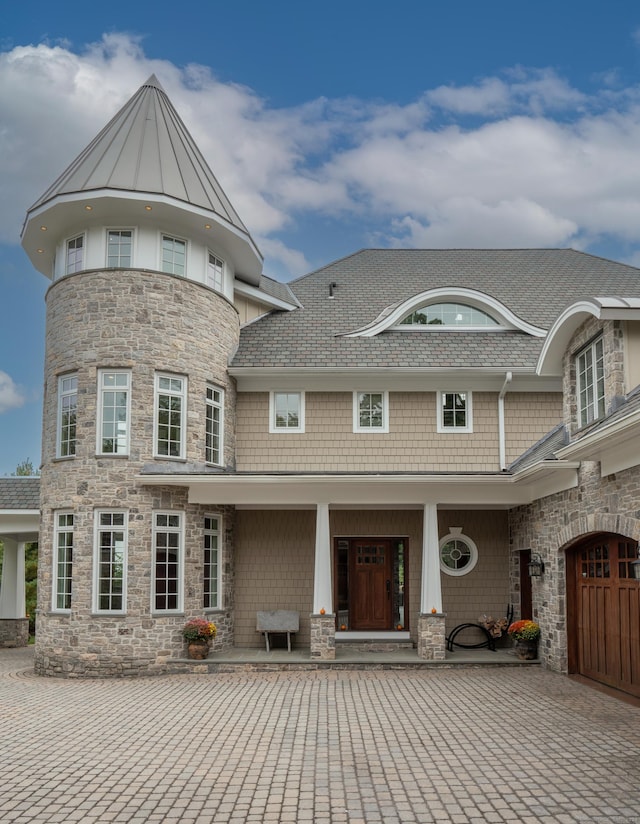 162 Balfour Dr, West Hartford, CT 06117 - view of front facade with stone siding, covered porch, a standing seam roof, and roof with shingles