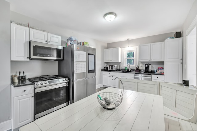 kitchen featuring white cabinets, stainless steel appliances, and sink