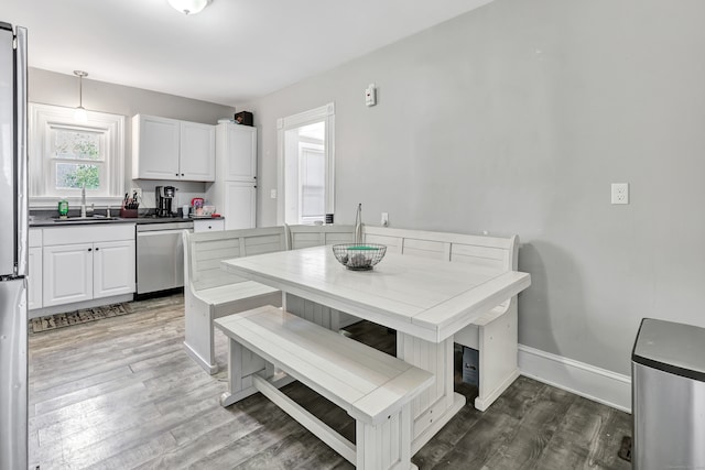 dining room with hardwood / wood-style floors and sink