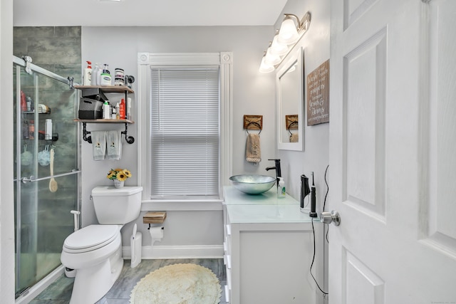 bathroom featuring vanity, toilet, and an enclosed shower