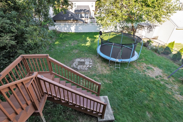 exterior space with a deck and a trampoline