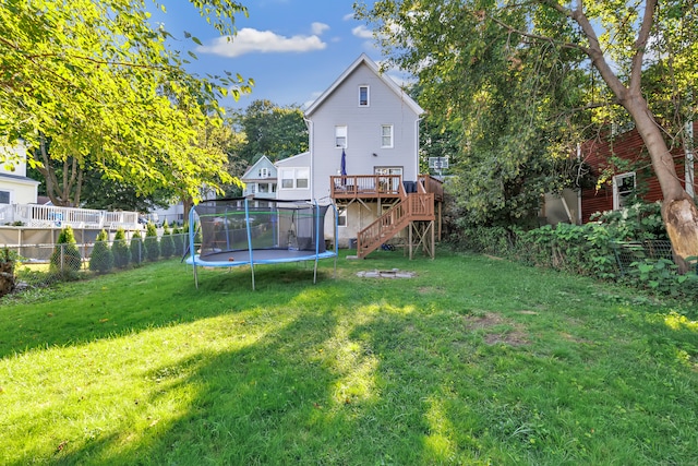 view of yard featuring a deck and a trampoline