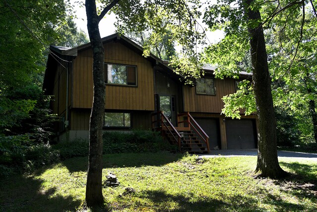 8 Candleview Dr, Sherman, CT 06784 - bi-level home featuring a front lawn, stairs, driveway, and a garage