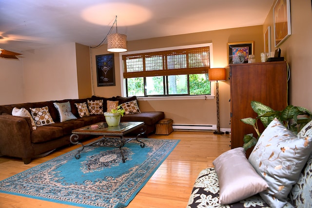 living room with light wood-type flooring and a baseboard radiator