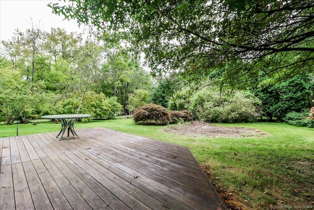 wooden terrace with a lawn