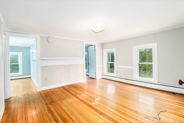 spare room with light hardwood / wood-style flooring and a baseboard heating unit