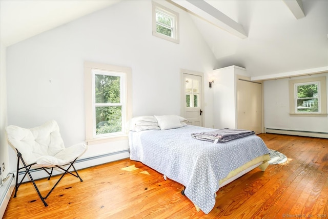 bedroom with hardwood / wood-style floors, beam ceiling, baseboard heating, and high vaulted ceiling