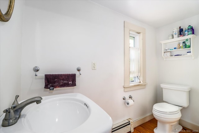 bathroom featuring sink, toilet, wood-type flooring, and baseboard heating