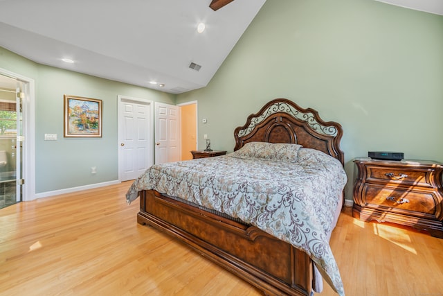 bedroom with wood-type flooring, connected bathroom, high vaulted ceiling, and ceiling fan