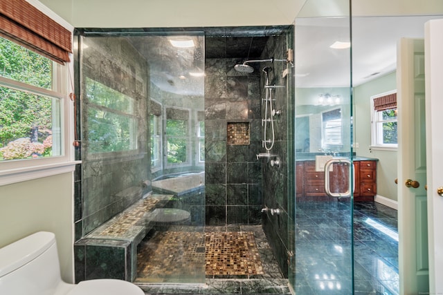 full bathroom featuring toilet, a tile shower, marble finish floor, and vanity
