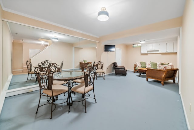 dining area featuring baseboards and carpet flooring