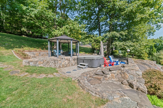 view of yard with a hot tub, a gazebo, and a patio area