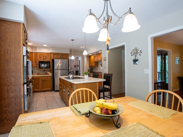 dining space with light tile patterned floors and a notable chandelier