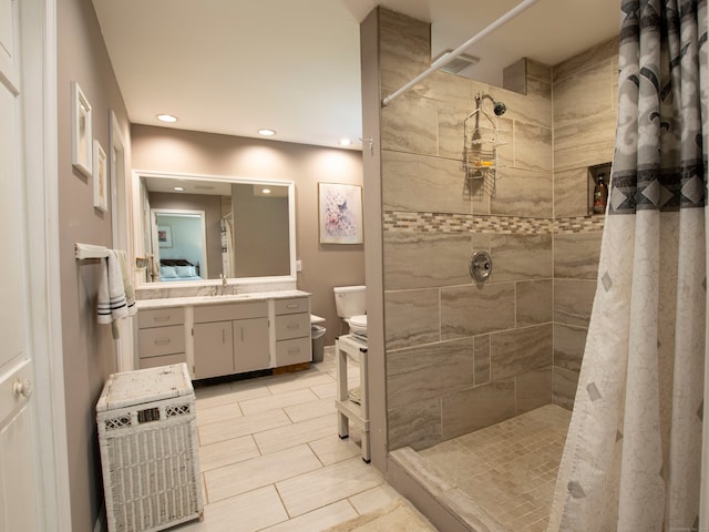 bathroom featuring walk in shower, vanity, and toilet