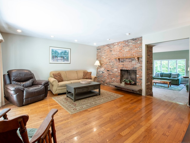 living room featuring a fireplace and light hardwood / wood-style flooring