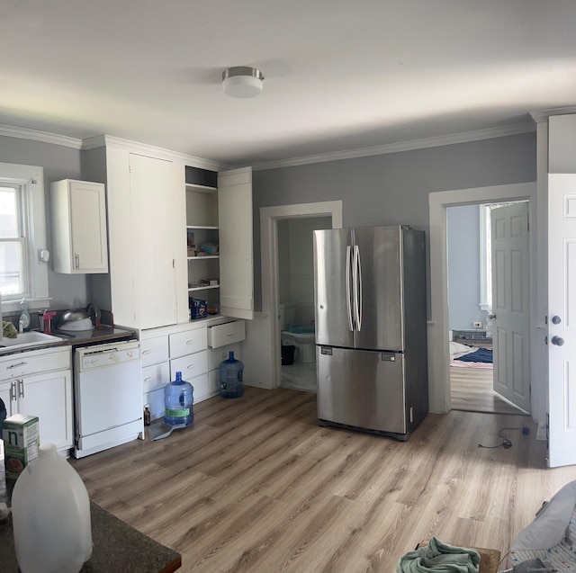 kitchen featuring stainless steel fridge, light wood-type flooring, white dishwasher, and white cabinetry