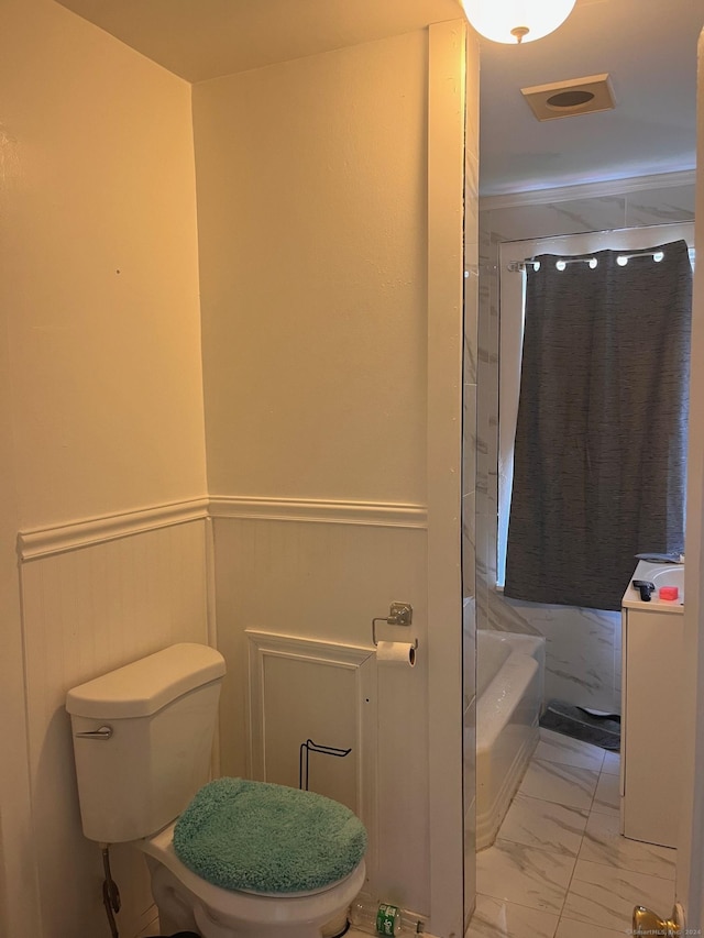 bathroom featuring a washtub and toilet