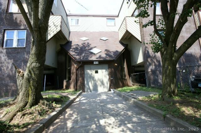 view of front of house with concrete driveway and brick siding