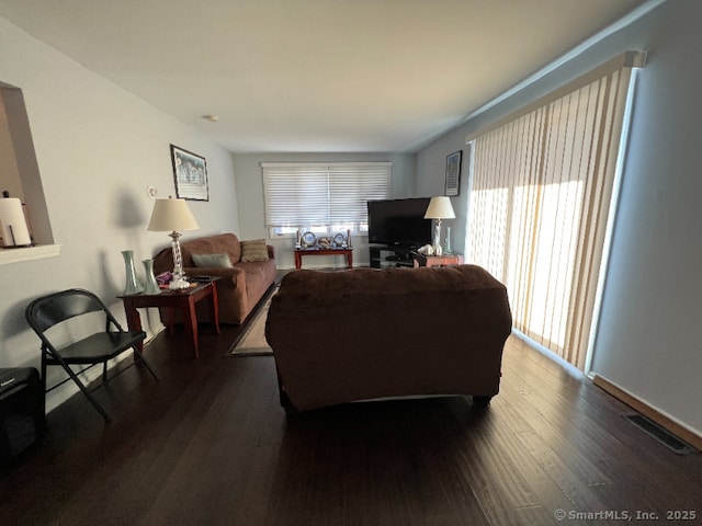 living room featuring dark wood-style flooring and visible vents