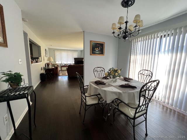 dining area with a chandelier and dark wood-style floors