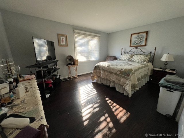 bedroom featuring dark wood-style flooring and baseboards
