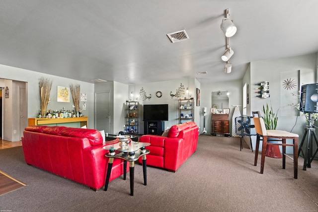 carpeted living room with track lighting