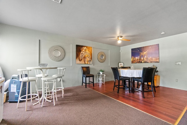 dining area with ceiling fan and dark hardwood / wood-style flooring