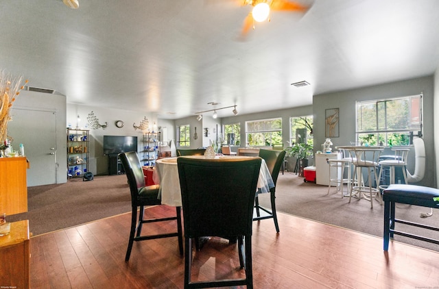 dining room featuring hardwood / wood-style flooring, ceiling fan, and rail lighting