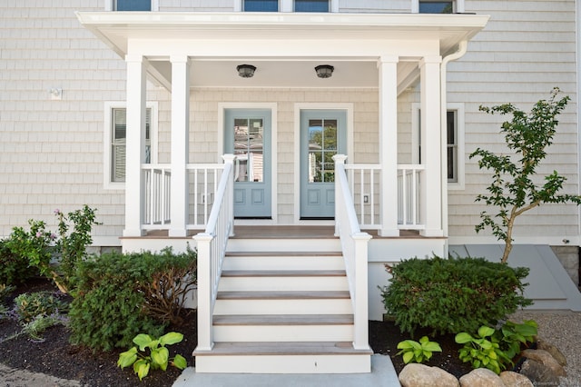 view of exterior entry featuring covered porch