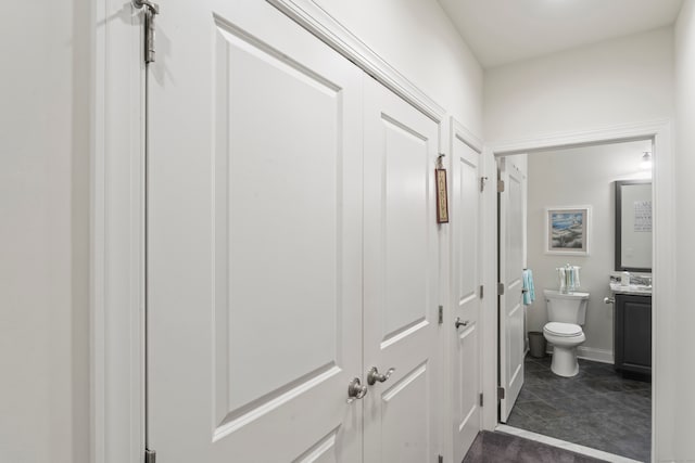 hall featuring dark tile patterned flooring