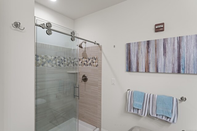 bathroom with a shower with shower door