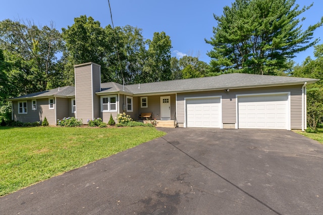 single story home with a garage and a front lawn