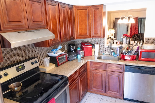 kitchen featuring tasteful backsplash, light tile patterned floors, stainless steel appliances, exhaust hood, and sink