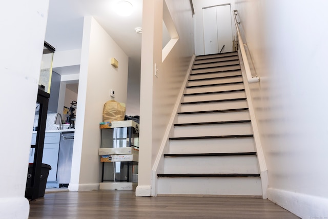 stairway with hardwood / wood-style flooring