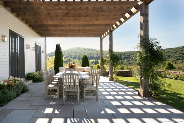 view of patio / terrace featuring a pergola and a mountain view