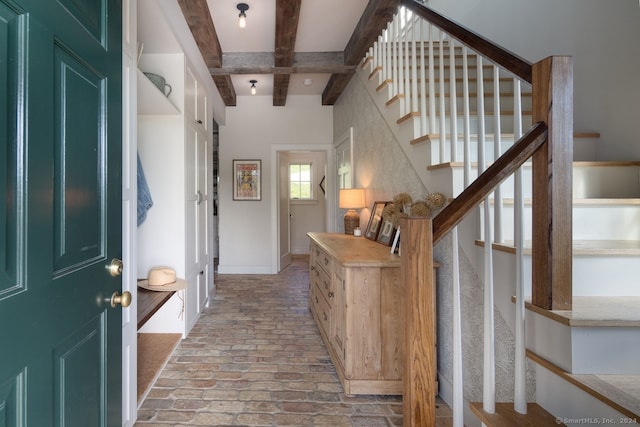 entryway featuring beam ceiling