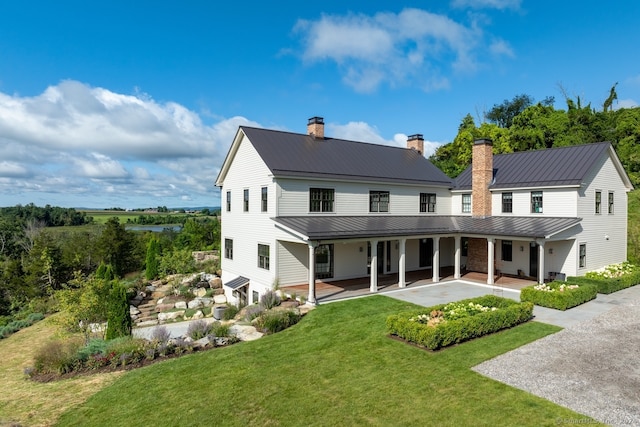 rear view of house featuring a lawn