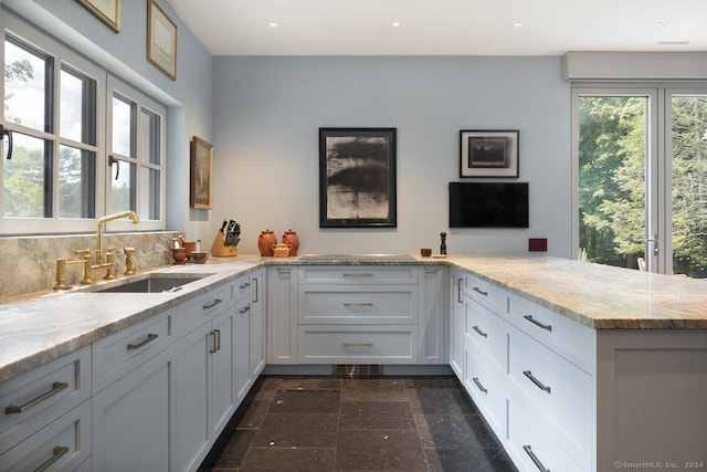 89 Under Mountain Rd, Canaan, CT 06031 - kitchen with light stone countertops, recessed lighting, white cabinetry, and a peninsula